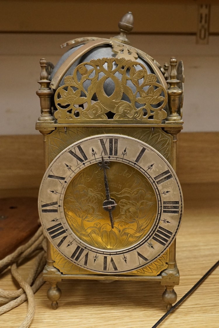 R. Arnold, Bodmin, a lantern clock on wooden wall shelf, clock 32cm high